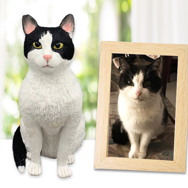 A polymer clay cat cake topper in the shape of a cat with a bobblehead design