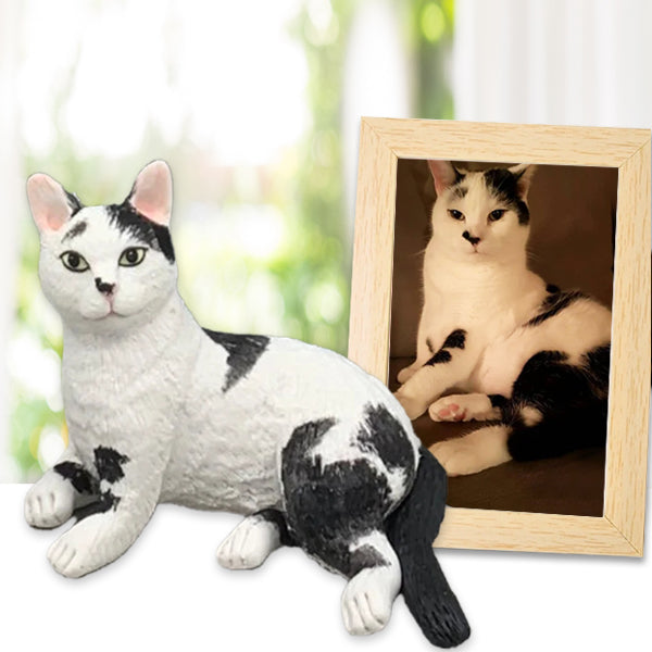 A personalized cat cake topper made of polymer clay